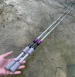 White and purple travel fishing rods with grey foam grips shown outdoors