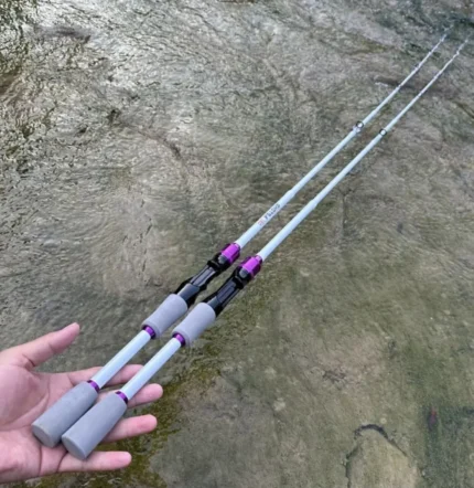 White and purple travel fishing rods with grey foam grips shown outdoors